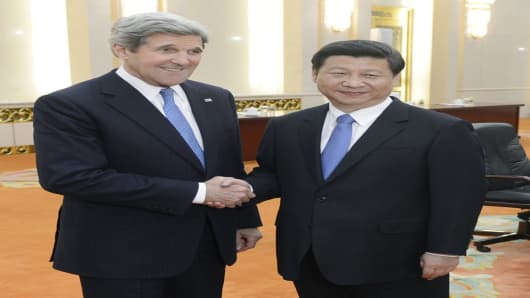 U.S. Secretary of State John Kerry shakes hands with Chinese President Xi Jinping before their meeting at the Great Hall of the People in Beijing on April 13, 2013.
